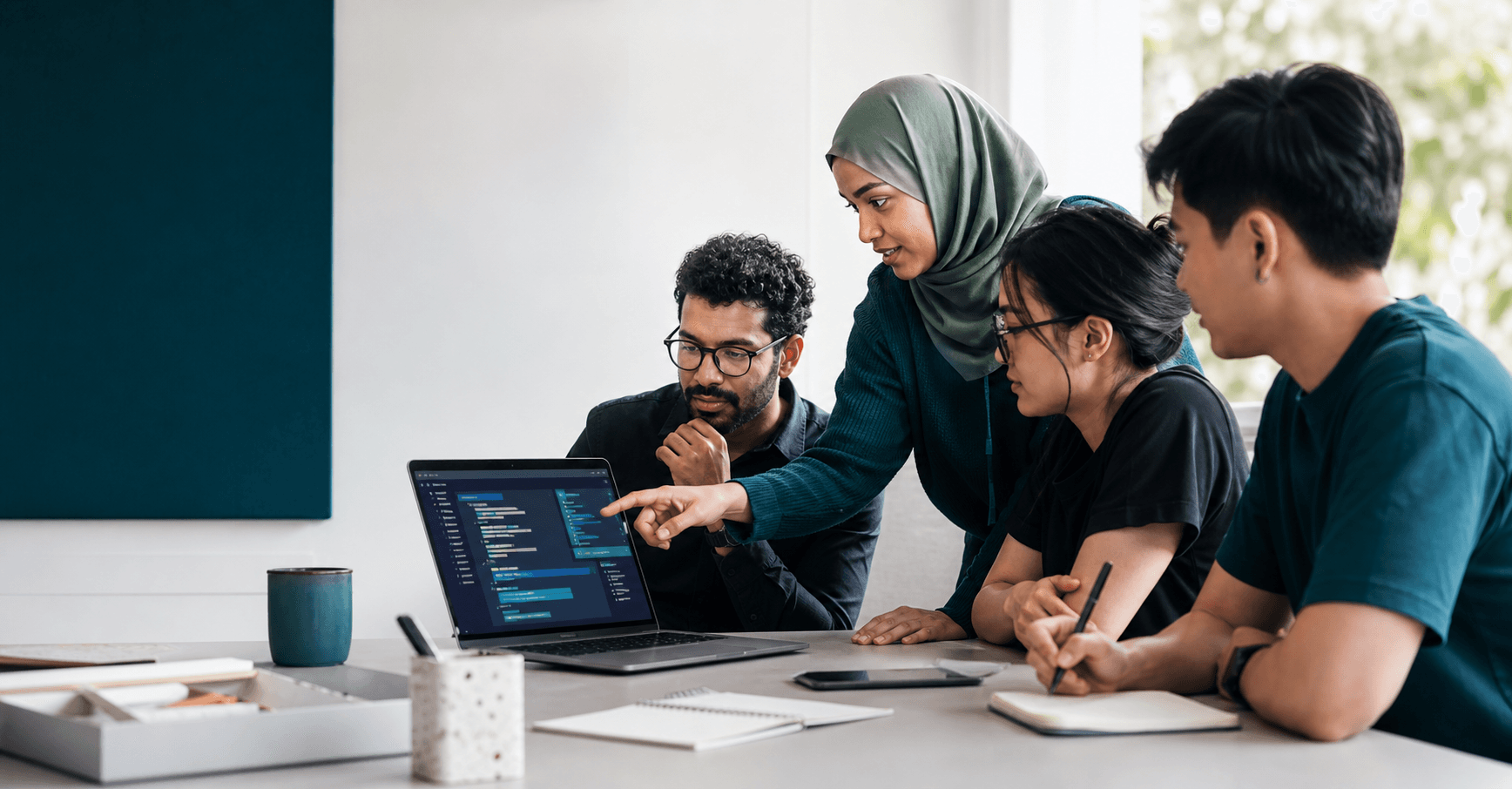 A small team learning AI-assisted coding around a laptop.